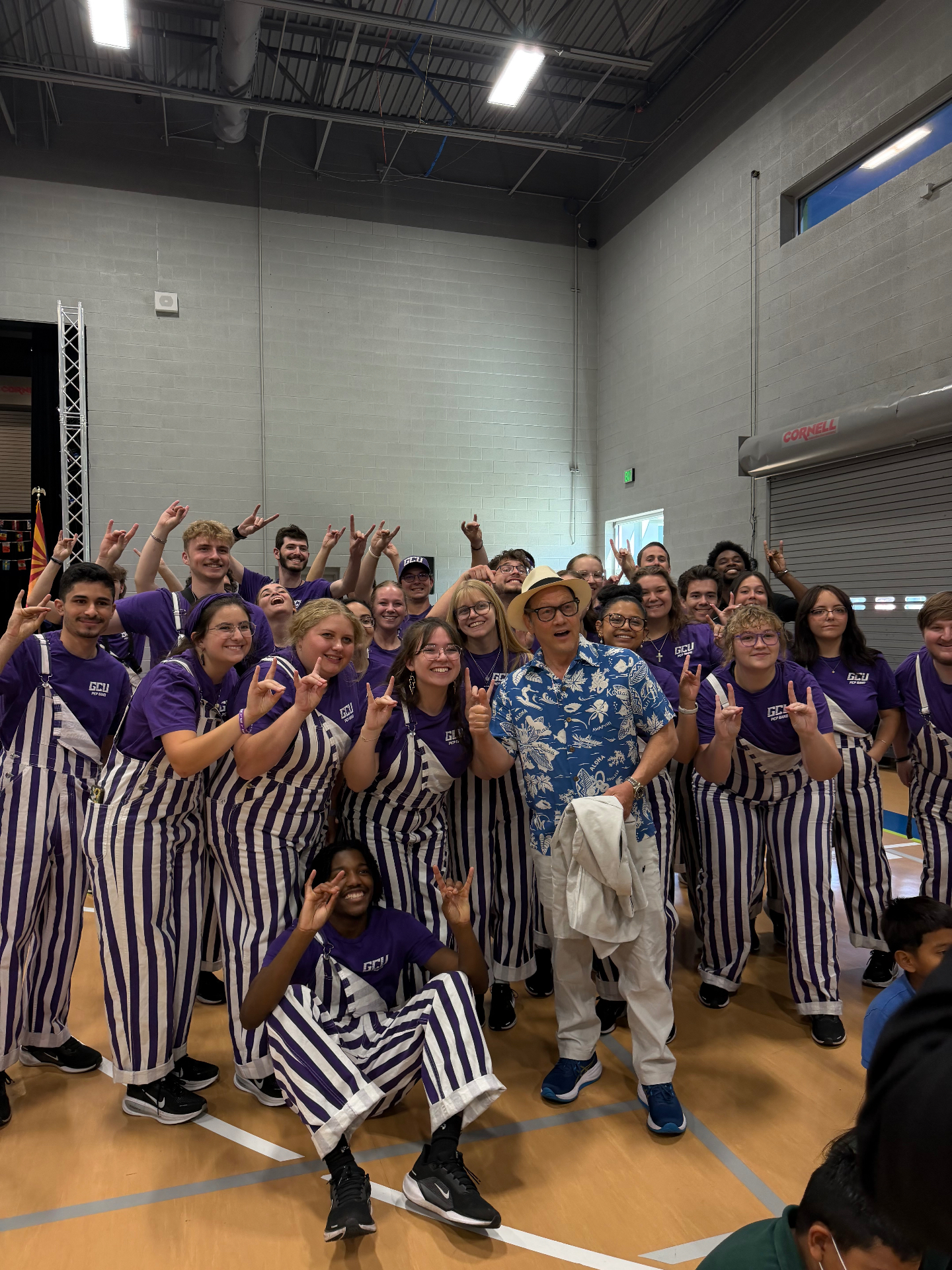 Group photo with the GCU pep band and supporters at a community event