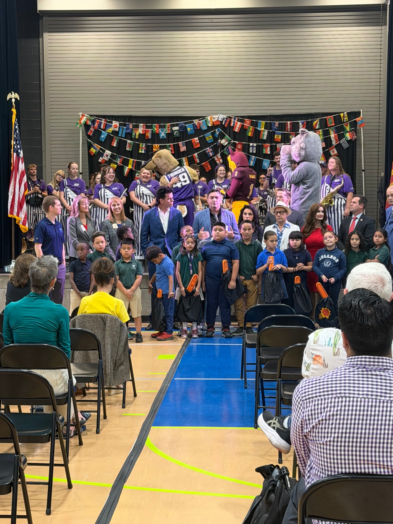 Students gathered at a school assembly with GCU band, mascots, and elected officials